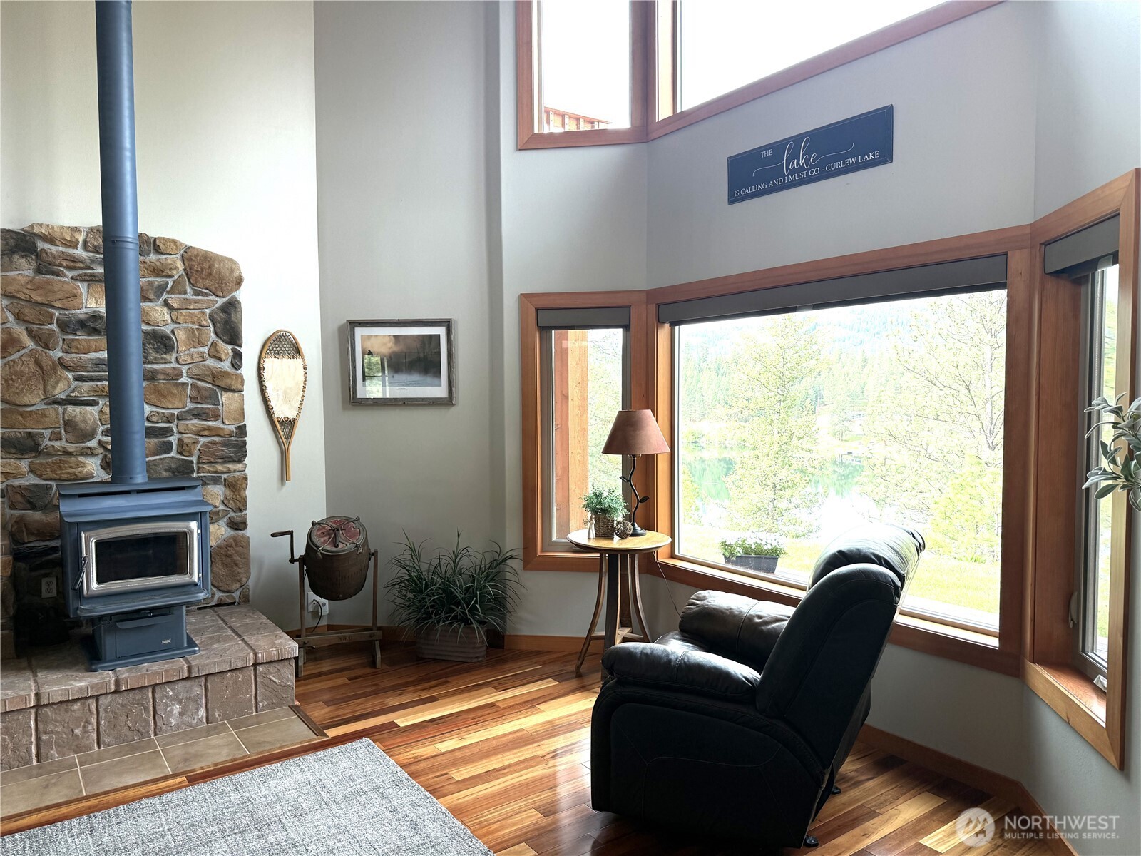 8 Julian Bay Road Republic, WA 99166 - Photo 5 of 40 a living room with furniture a fireplace and a floor to ceiling window