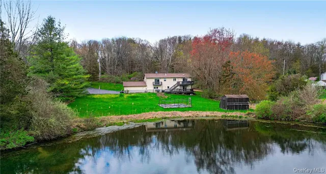 a view of a lake with a house in the background
