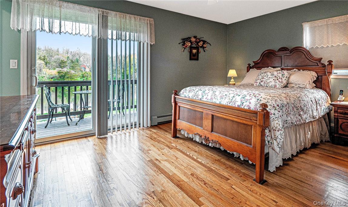 26 Waterbury Road Warwick, NY 10990 - Photo 12 of 30 a bedroom with a bed and a large window with wooden floor