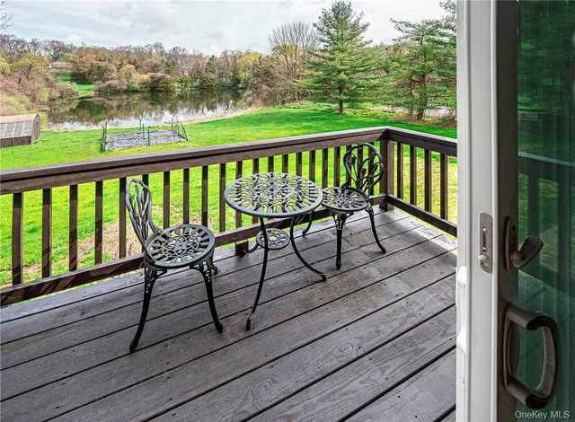 a view of a chairs and table on the balcony