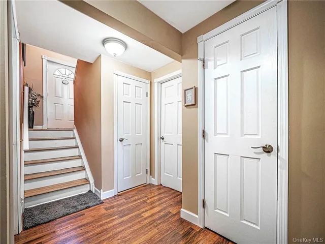 a view of a hallway with wooden floor and entryway
