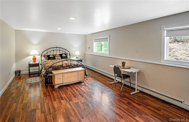 a bedroom with furniture and a wooden floor