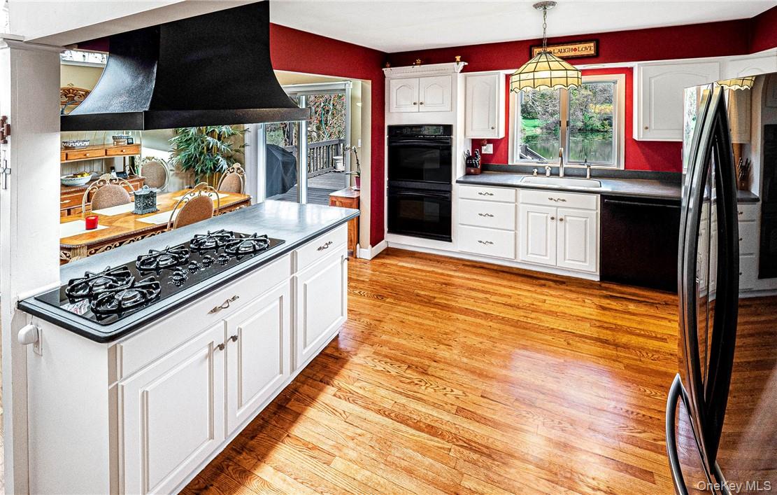 26 Waterbury Road Warwick, NY 10990 - Photo 8 of 30 a kitchen with stainless steel appliances kitchen island granite countertop a stove a refrigerator and wooden cabinets