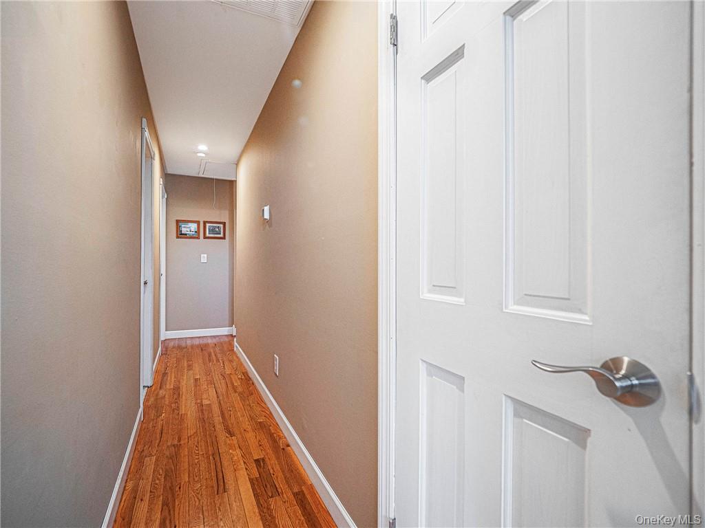 26 Waterbury Road Warwick, NY 10990 - Photo 10 of 30 a view of a hallway with wooden floor and a bathroom