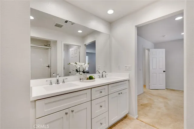 a spacious bathroom with a double vanity sink mirror and