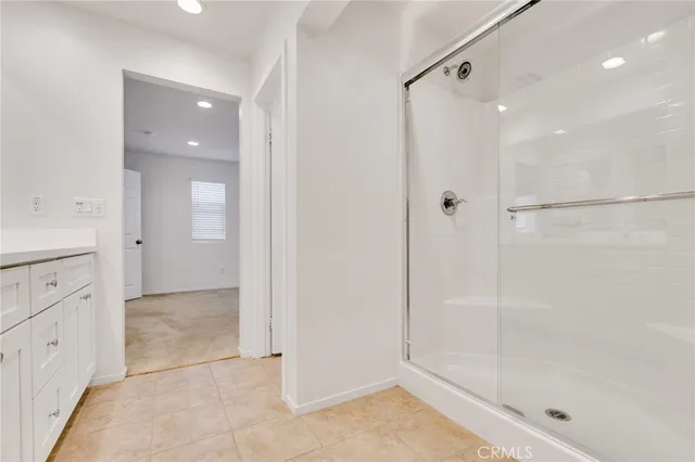 a bathroom with a shower and a glass door