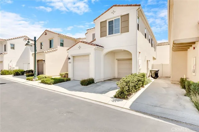 a front view of a white house with a yard and garage