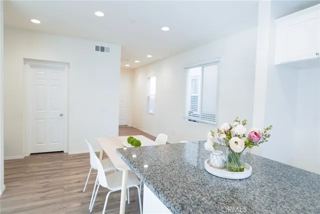 a dining room with furniture and wooden floor