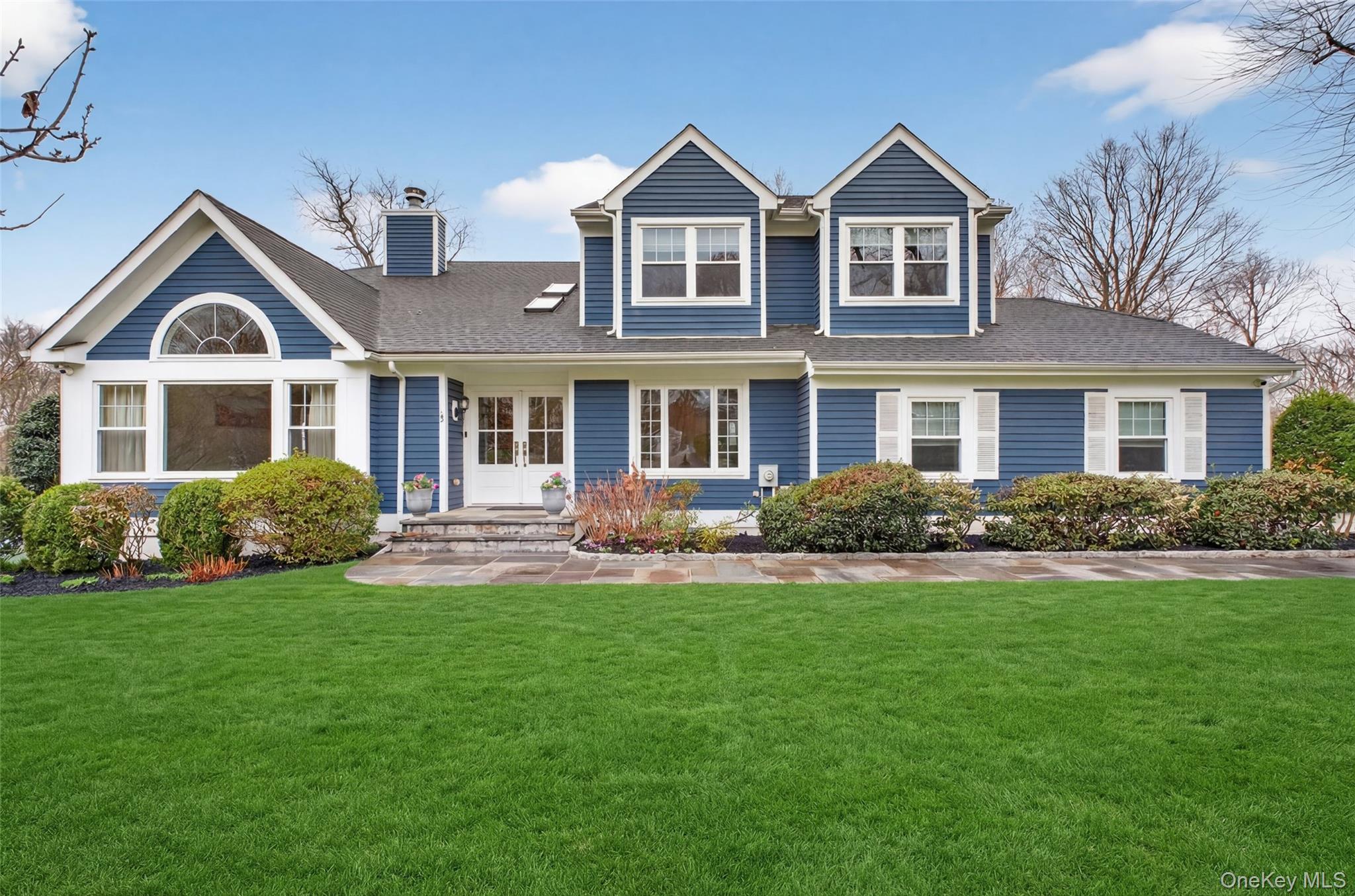 45 East Hill Road Cortlandt Manor, NY 10567 - Photo 1 of 48 a front view of a house with a garden
