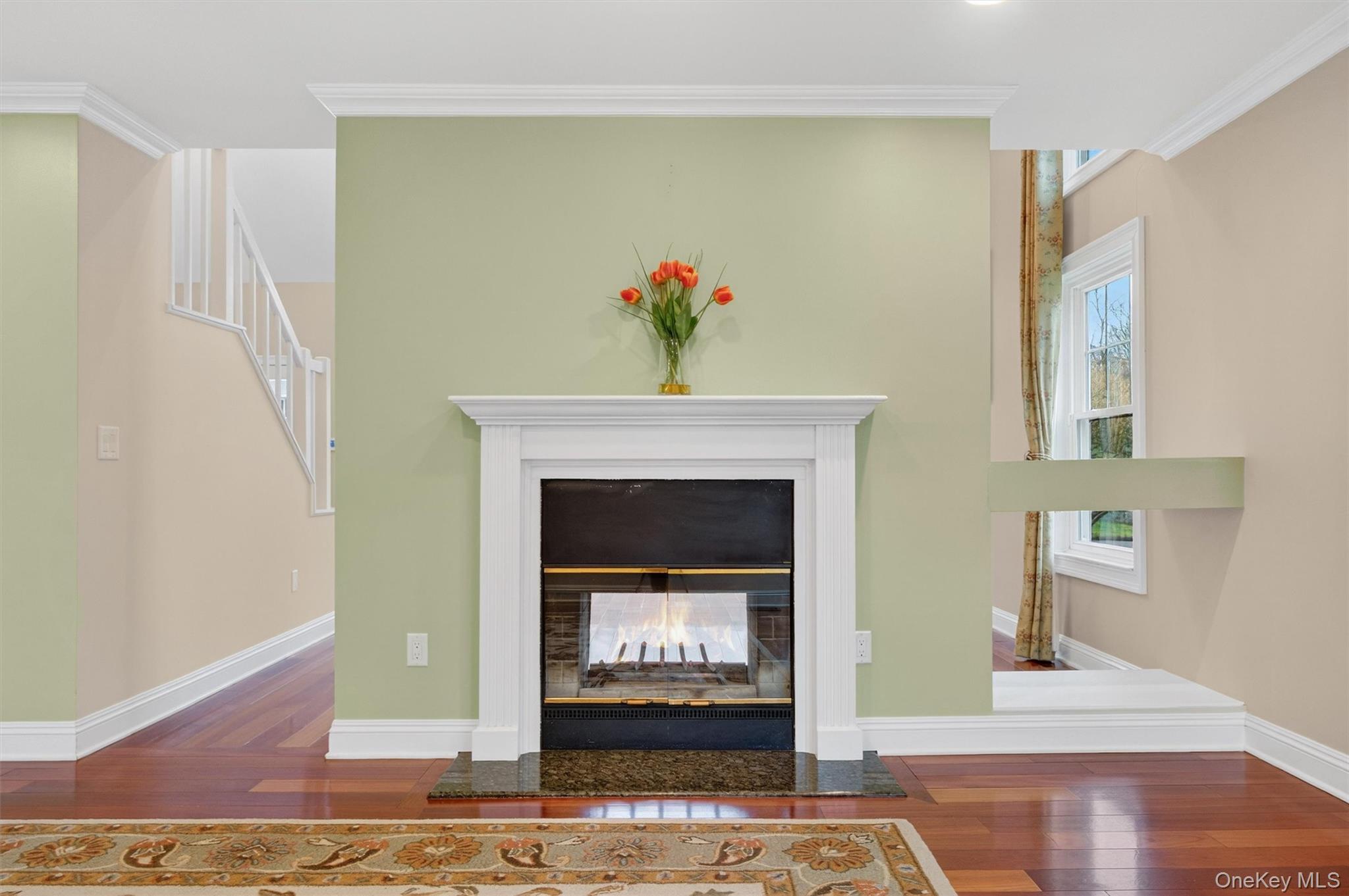 45 East Hill Road Cortlandt Manor, NY 10567 - Photo 14 of 48 a view of an empty room with wooden floor a fireplace and a window