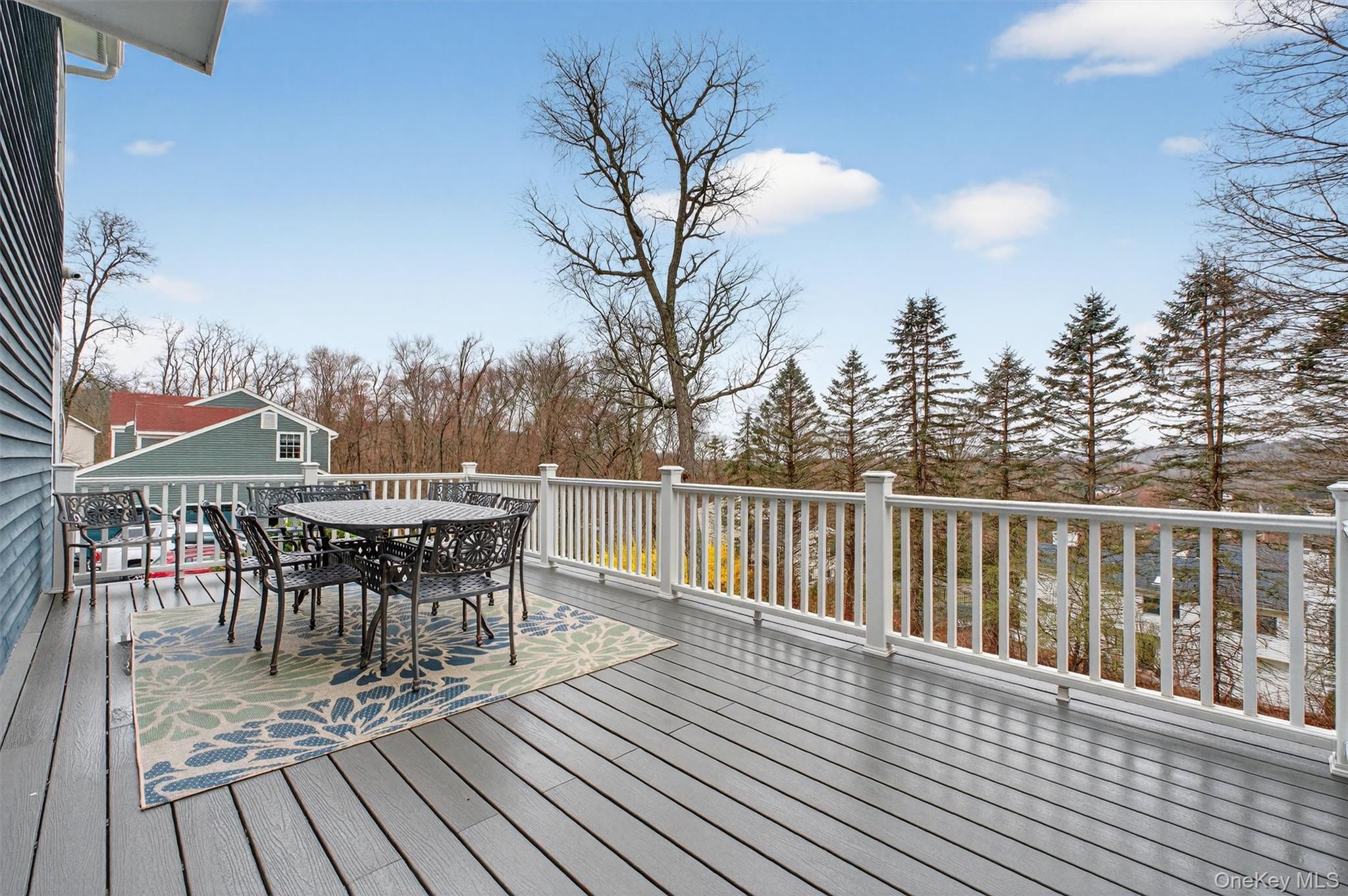 45 East Hill Road Cortlandt Manor, NY 10567 - Photo 34 of 48 a view of a roof deck with table and chairs a barbeque with wooden floor and fence