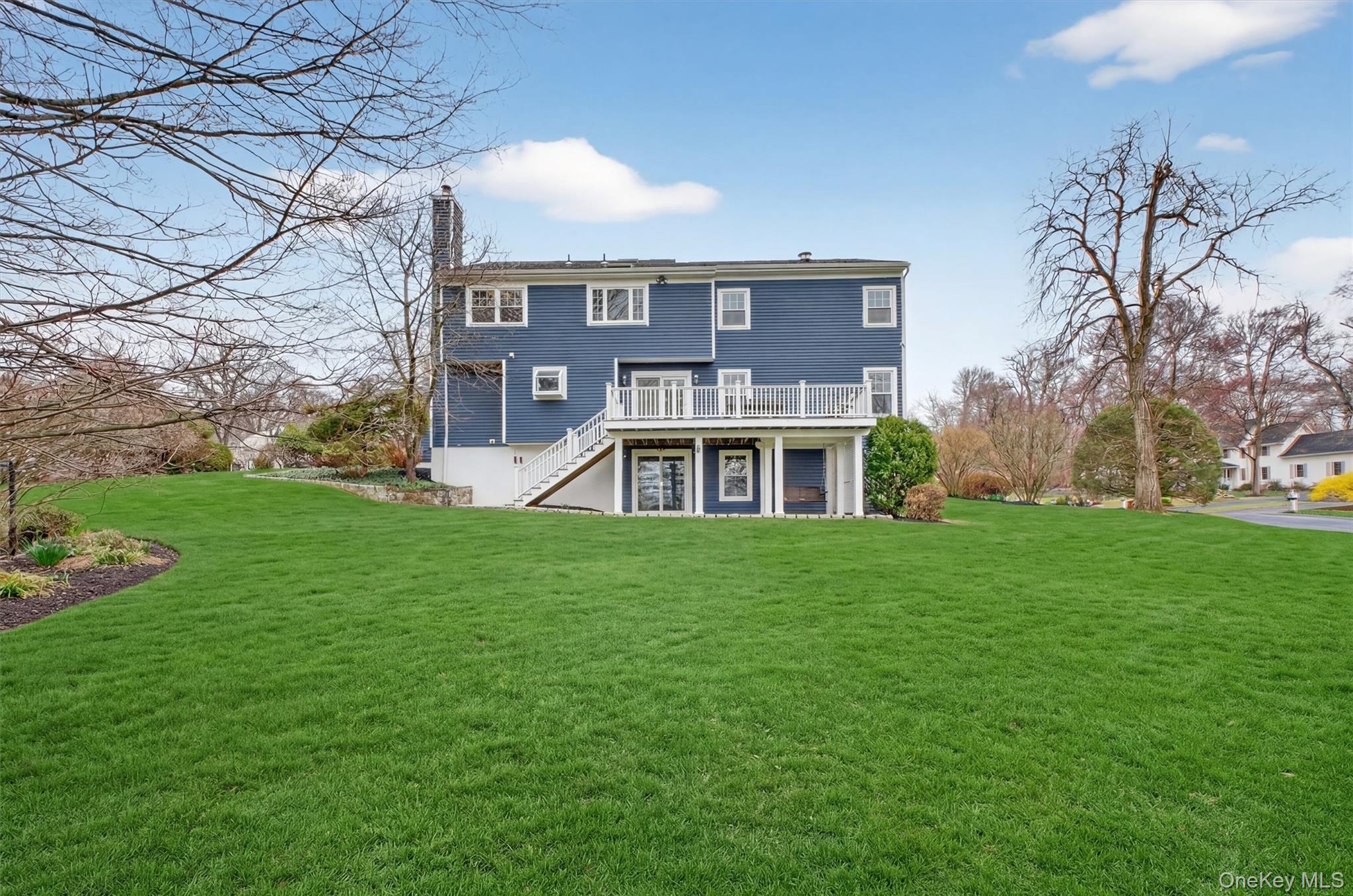 45 East Hill Road Cortlandt Manor, NY 10567 - Photo 35 of 48 a view of a big house with a big yard and large trees