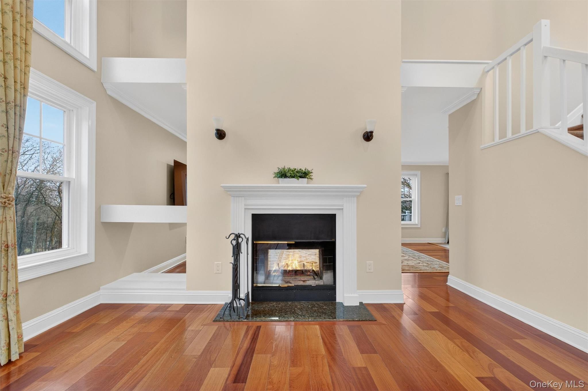 45 East Hill Road Cortlandt Manor, NY 10567 - Photo 5 of 48 a view of an empty room with wooden floor fireplace and a window