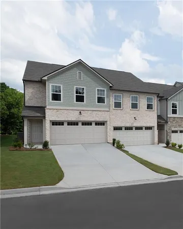 a front view of a house with a garden and yard