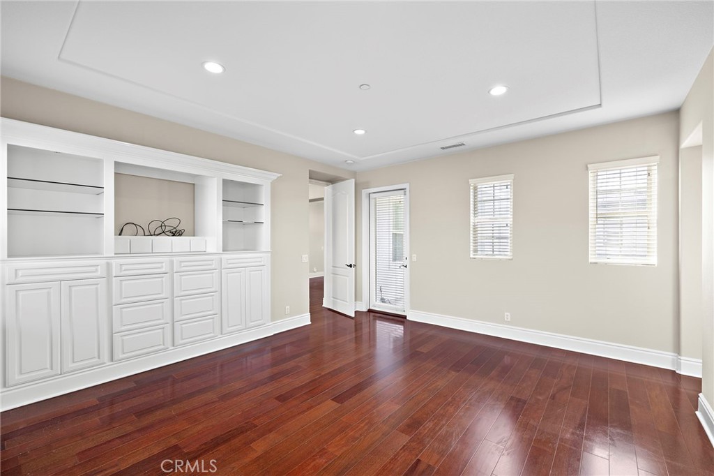 3 Eric Street Ladera Ranch, CA 92694 - Photo 13 of 35 a view of a kitchen with wooden floor and white cabinets
