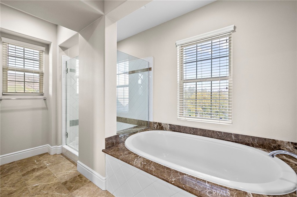 3 Eric Street Ladera Ranch, CA 92694 - Photo 15 of 35 a bath tub sitting in a bathroom next to a window