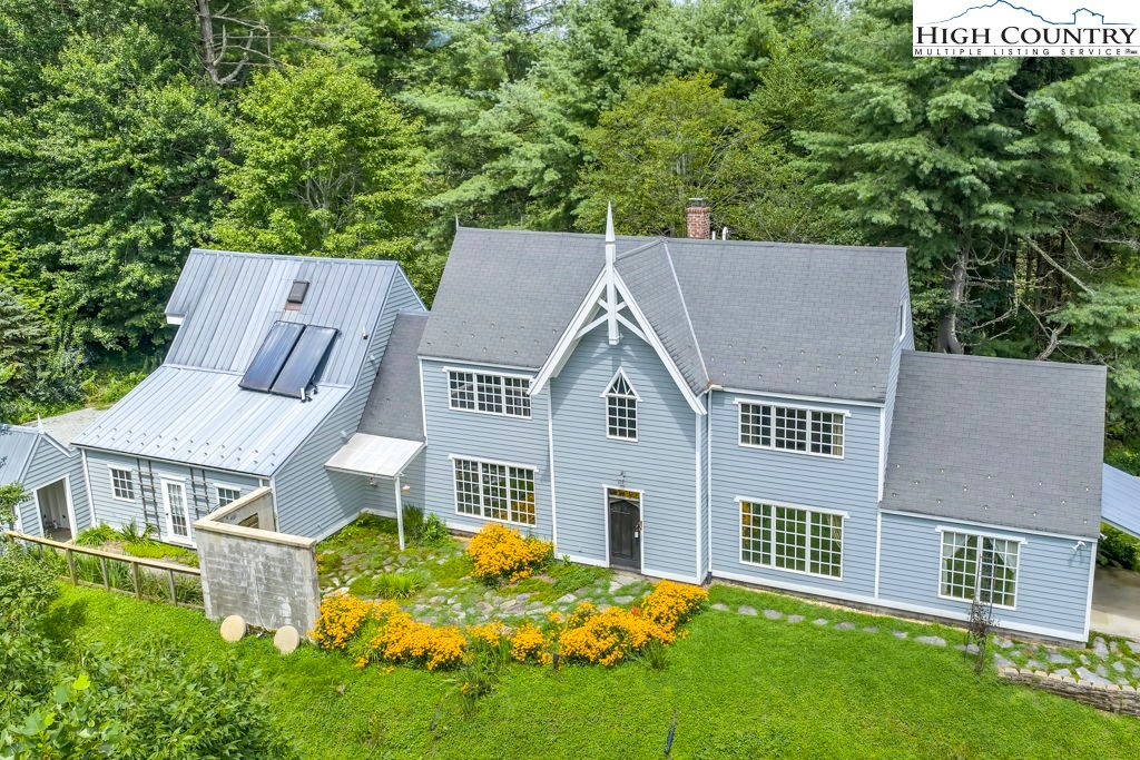 aerial view of a house with a yard