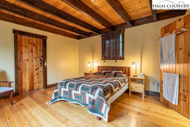 a bedroom with a bed and a table