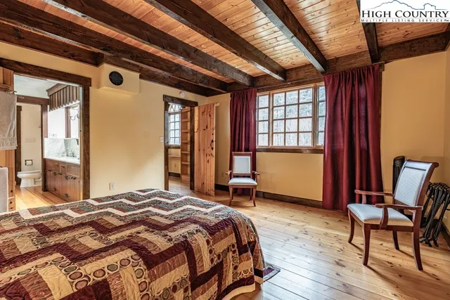 a spacious bedroom with a bed and a chair