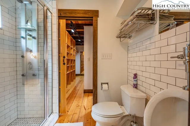 a bathroom with a toilet and shower