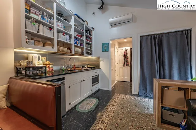 a kitchen with stainless steel appliances granite countertop a stove a refrigerator and a cabinets