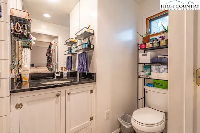 a bathroom with a toilet sink and mirror
