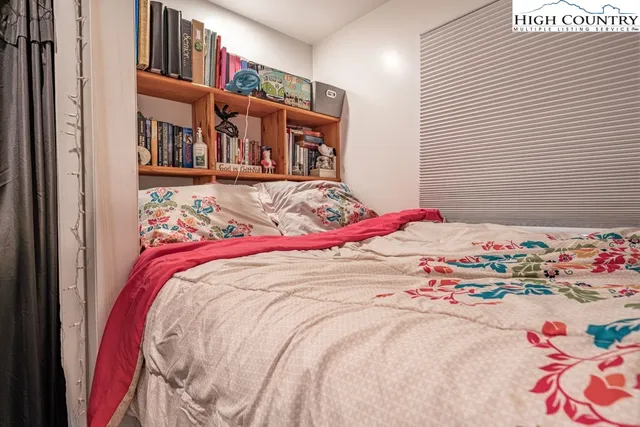 a bed with a bed and a painting on the wall