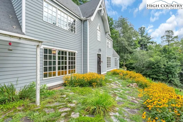 a view of house with backyard and garden
