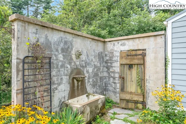 a backyard of a house with table and chairs