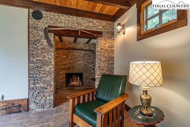 a living room with furniture a fireplace and a wooden floor