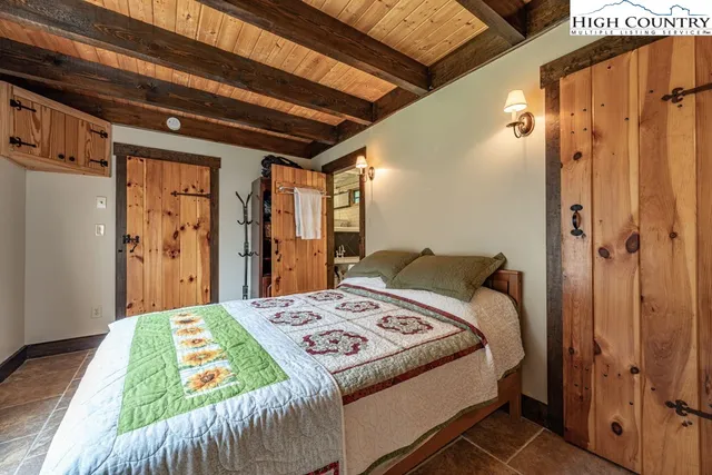 a bed sitting in a bedroom next to a window