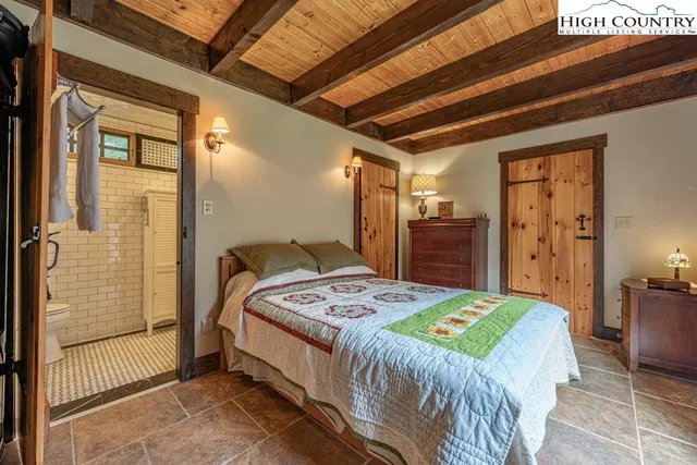 a bedroom with a bed next to a window