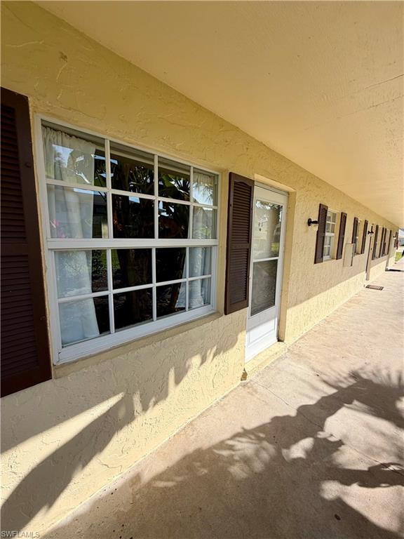 3325 Airport Road North, Unit N3 Naples, FL 34105 - Photo 2 of 12 a view of a house with a wooden floor and a floor to ceiling window
