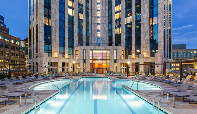 a view of a swimming pool with outdoor seating