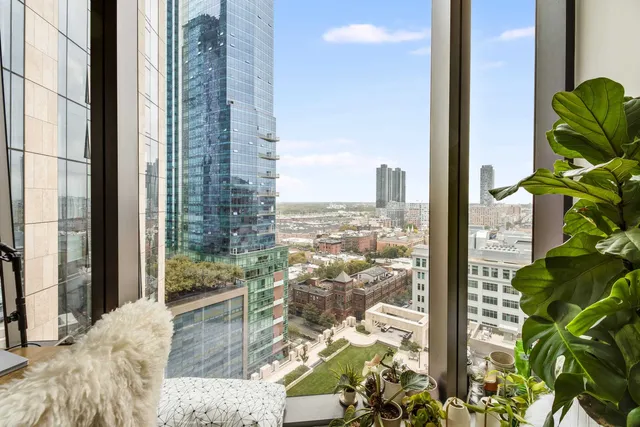 a view of a balcony with floor to ceiling windows with wooden floor