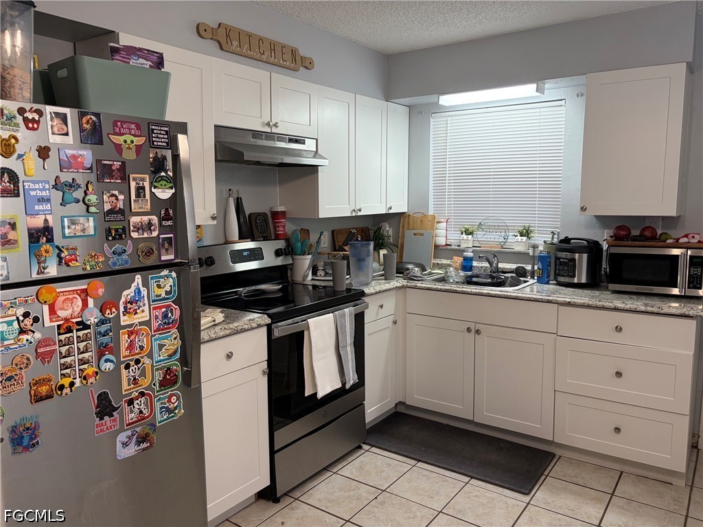 2175 Twin Brooks Road North Fort Myers, FL 33917 - Photo 19 of 27 a kitchen with stainless steel appliances a stove a sink and cabinets