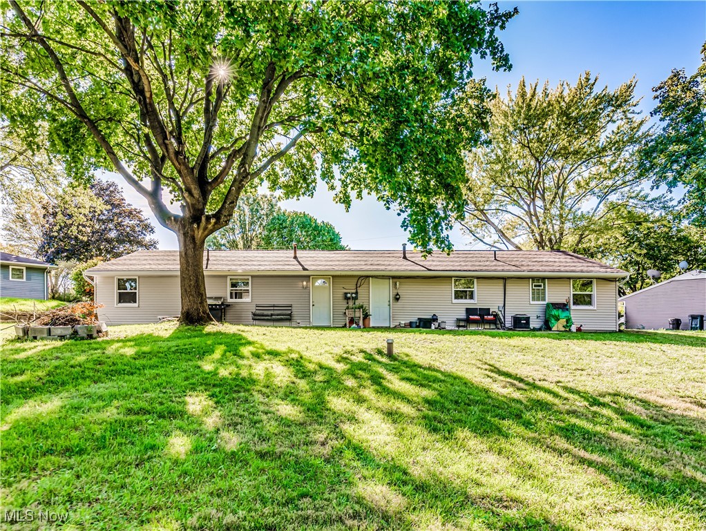 1119 Chaparrel Road Southwest Hartville, OH 44632 - Photo 22 of 23 Rear view of property featuring a lawn