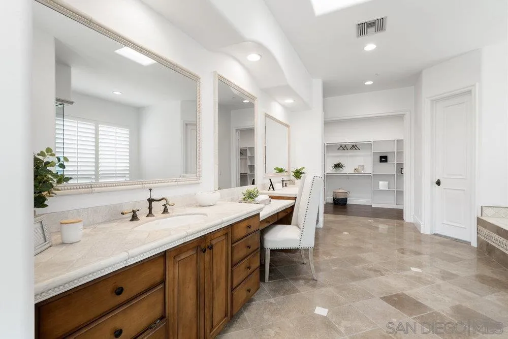 17864 Old Winemaster Way Poway, CA 92064 - Photo 14 of 22 a spacious bathroom with a granite countertop sink mirror and toilet