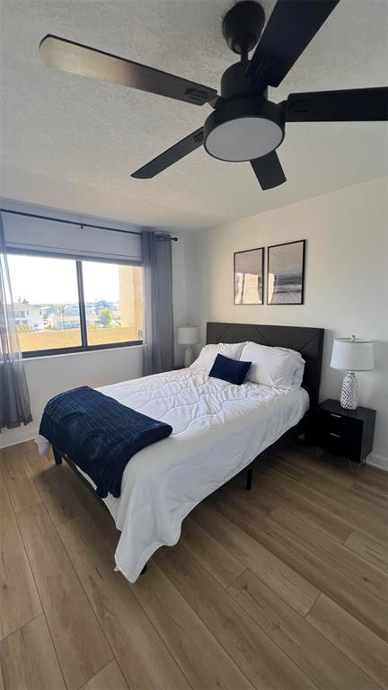 6035 Sea Ranch Drive, Unit 211 Hudson, FL 34667 - Photo 12 of 21 a bedroom with a bed and a large window