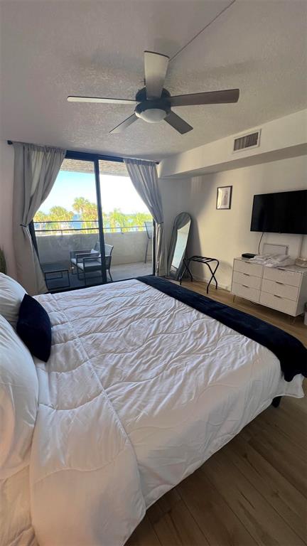 6035 Sea Ranch Drive, Unit 211 Hudson, FL 34667 - Photo 15 of 21 a bedroom with a bed and a large window