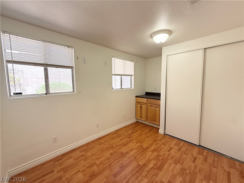 616 Greenway Road Henderson, NV 89002 - Photo 14 of 32 A versatile room featuring durable wood flooring and ample storage with a built-in cabinet.