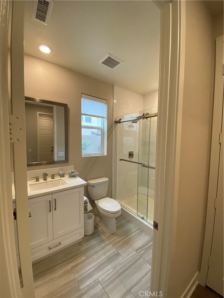 62 Hawking Irvine, CA 92618 - Photo 17 of 37 a bathroom with a sink a toilet a mirror and shower