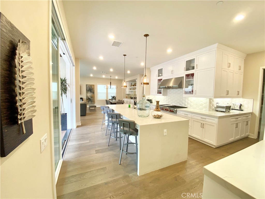 62 Hawking Irvine, CA 92618 - Photo 5 of 37 a large kitchen with a counter top space a sink stainless steel appliances and cabinets