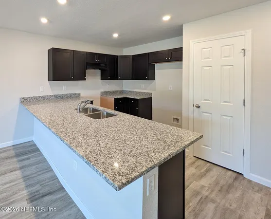 a kitchen with kitchen island a sink stainless steel appliances and cabinets