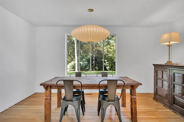 a view of a dining room with furniture window and wooden floor