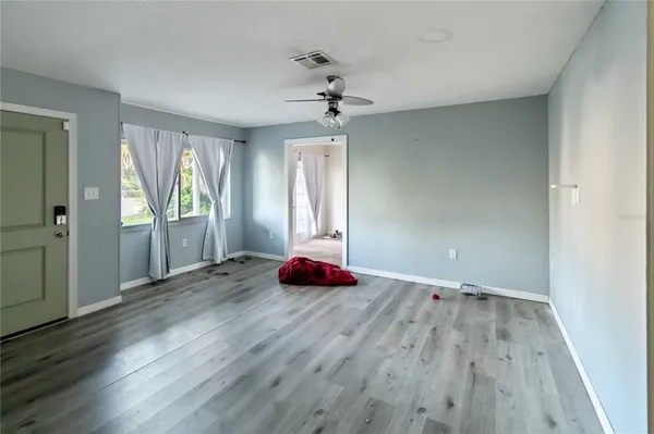 wooden floor in an empty room with a window