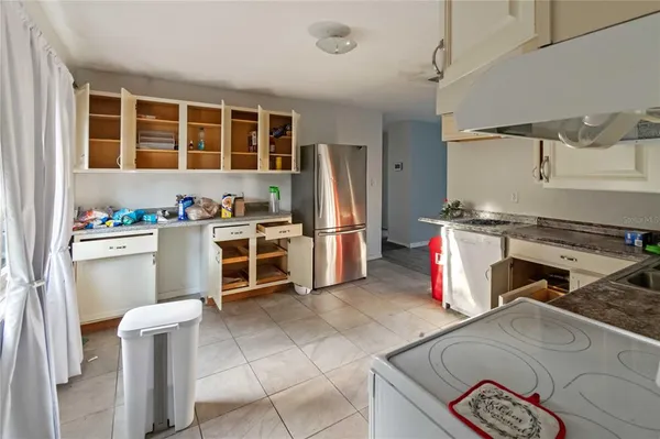 a kitchen with a stove a sink and a refrigerator