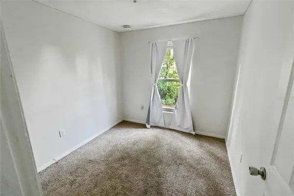 a view of an empty room with a window