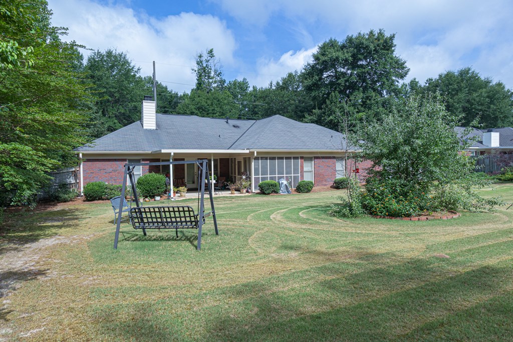 7386 Garrett Road Midland, GA 31820 - Photo 12 of 29 a front view of a house with a garden