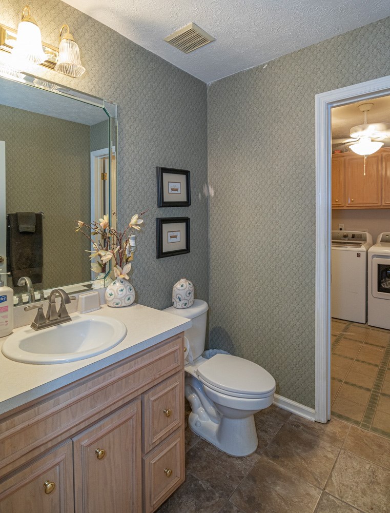 7386 Garrett Road Midland, GA 31820 - Photo 18 of 29 a bathroom with a toilet a sink and mirror